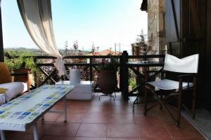 a balcony with a table and chairs and a view at - Ta Petrina - Traditional Stone-built Villa in Agios Nikolaos