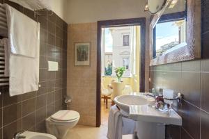 a bathroom with a sink and a toilet and a window at Vatican Domus in Rome +38 photos