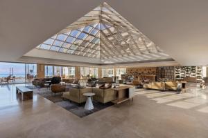 a living room with a large glass ceiling at Aria in Eilat