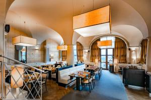 a restaurant with tables and chairs in a room at Hotel Větruše in Ústí nad Labem