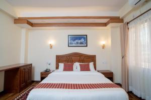 Voodi või voodid majutusasutuse Madhuban Hotel toas