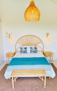 a bedroom with a large bed with blue pillows at Villa Possanco, Comporta beach villa in Comporta