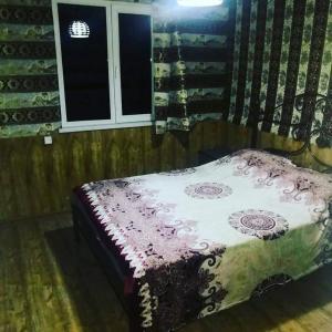 a bed sitting in a room with a window at Golden Beach Sevan in Tsovazard