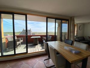 a living room with a view of a deck at Callantsoger Staete A305 in Callantsoog