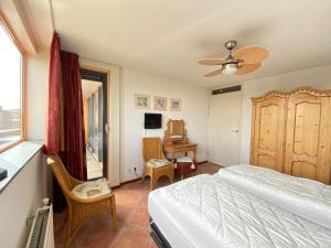 a bedroom with a bed and a desk and a window at Callantsoger Staete A305 in Callantsoog