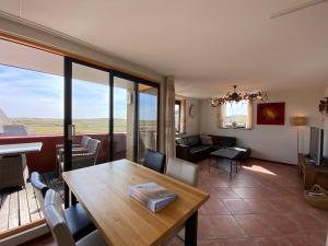 a living room with a wooden table and a couch at Callantsoger Staete A305 in Callantsoog