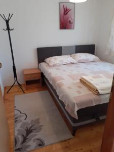 a bedroom with a bed and a lamp and a rug at Villa Giulia in Bihać