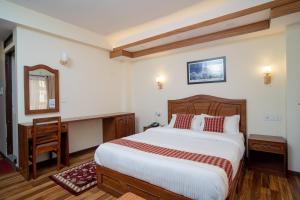Voodi või voodid majutusasutuse Madhuban Hotel toas