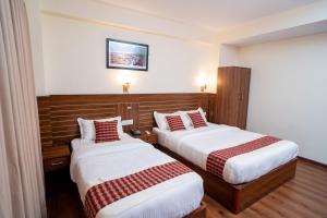 Voodi või voodid majutusasutuse Madhuban Hotel toas