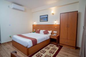 Voodi või voodid majutusasutuse Madhuban Hotel toas