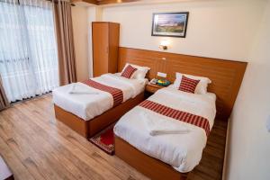 Voodi või voodid majutusasutuse Madhuban Hotel toas