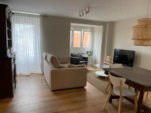 a living room with a couch and a table at Casa de la plaza in Foz