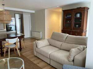 a living room with a couch and a table at Casa de la plaza in Foz +3 photos