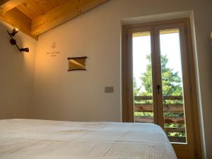 A bed or beds in a room at Chalet Baita delle Favole di RosaRita