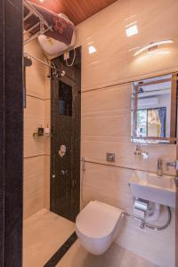 a bathroom with a toilet and a sink and a shower at SaffronStays Aster, plunge pool villa with garden, Lonavala in Lonavala