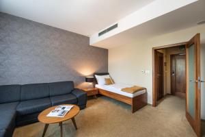 Postel nebo postele na pokoji v ubytování Hotel Větruše