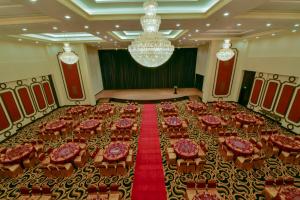 a large banquet room with many tables and chairs at Aristo International Hotel in Lao Cai