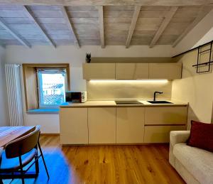 a kitchen with a couch and a table in a room at Nobilia Dimore - Suite & Spa Privata in Stia