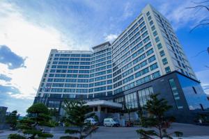 a tall building with a lot of windows at Aristo International Hotel in Lao Cai