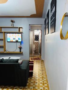 a living room with a couch and a television at Loaded homes in Kikuyu +62 photos