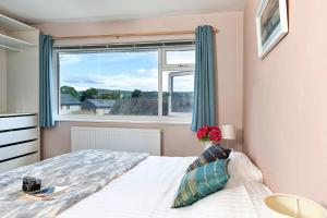 a bedroom with a bed and a large window at Finest Retreats - Helm View in Kendal