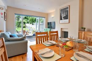 a dining room and living room with a table and chairs at Finest Retreats - Helm View in Kendal