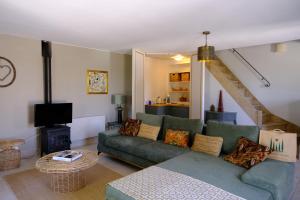 a living room with a couch and a fireplace at Domaine Le Bois Des Dames in Chantemerle-lès-Grignan