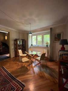 a living room with a table and chairs at Hangvilla vendégház in Miskolc