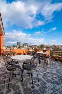a patio with tables and chairs on a roof at Madhuban Hotel in Kathmandu