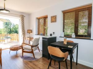 un soggiorno con tavolo e sedie di The Wood Shed, Bank Top Farm ad Ashbourne