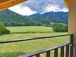 a view from a balcony of a green field and mountains at Ferienwohnung Bergblick Loft in Aschau im Chiemgau