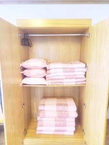 a closet filled with lots of folded towels at Dombe Resort in Seogwipo