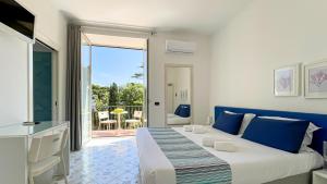 a bedroom with a large bed and a balcony at Hotel Spicy in Sorrento