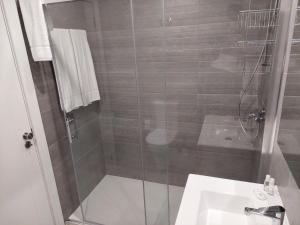 a bathroom with a shower and a sink at Cool Suites in Porto +40 photos
