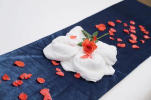 a flower made out of towels on a blue plate with hearts at Five Elephants Hotel in Sihanoukville