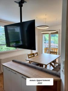 a living room with a table and a flat screen tv at Frühstückspension Wagrain - Viktoria Flasch in Wagrain