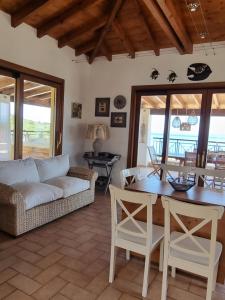 a living room with a couch and a table at Paxos villas in Gaios