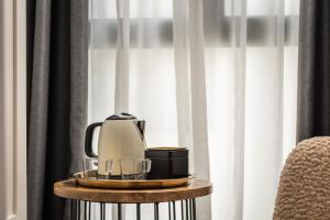 a coffee maker on a table next to a window at BYPILLOW La Sal in Cádiz