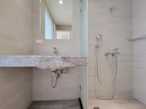 a bathroom with a sink and a shower at CHECK inn Express Taichung Fuxing in Taichung
