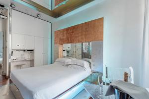 Un pat sau paturi într-o cameră la Hotel Trecento
