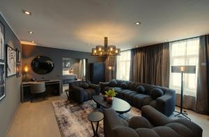 a living room with a couch and a table at The Lamp Hotel & Spa in Norrköping