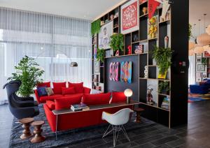 a living room with a red couch and a table at citizenM Washington DC NoMa in Washington, D.C.