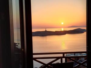 a view of a sunset from a room at Villas El Paradiso in Kouroúpi