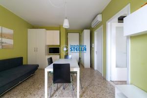 - un salon avec une table et un canapé dans l'établissement Condominio Commerciale, à Lido di Jesolo
