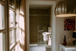 a bathroom with a sink and a toilet and a mirror at el gran sueño Boutique Hotel & Apartamentos - Adults Only in Pintueles