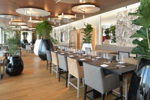 a dining room with a long table and chairs at NH Collection Olomouc Congress in Olomouc