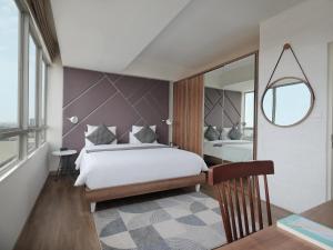 Ein Bett oder Betten in einem Zimmer der Unterkunft Fika Rooms Tangerang By Skandinavia
