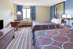 a hotel room with two beds and a desk at Super 8 by Wyndham Monee I-57 in Monee