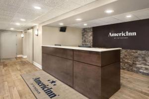 a lobby of an american firm with a reception desk at AmericInn by Wyndham Rapid City in Rapid City