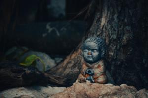 a small statue sitting on top of a rock at La Casa del K&eacute;ej Hostel in M&eacute;rida